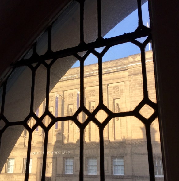 Two libraries captured as one as the shadow of Edinburgh Central Library falls against the National Library of Scotland